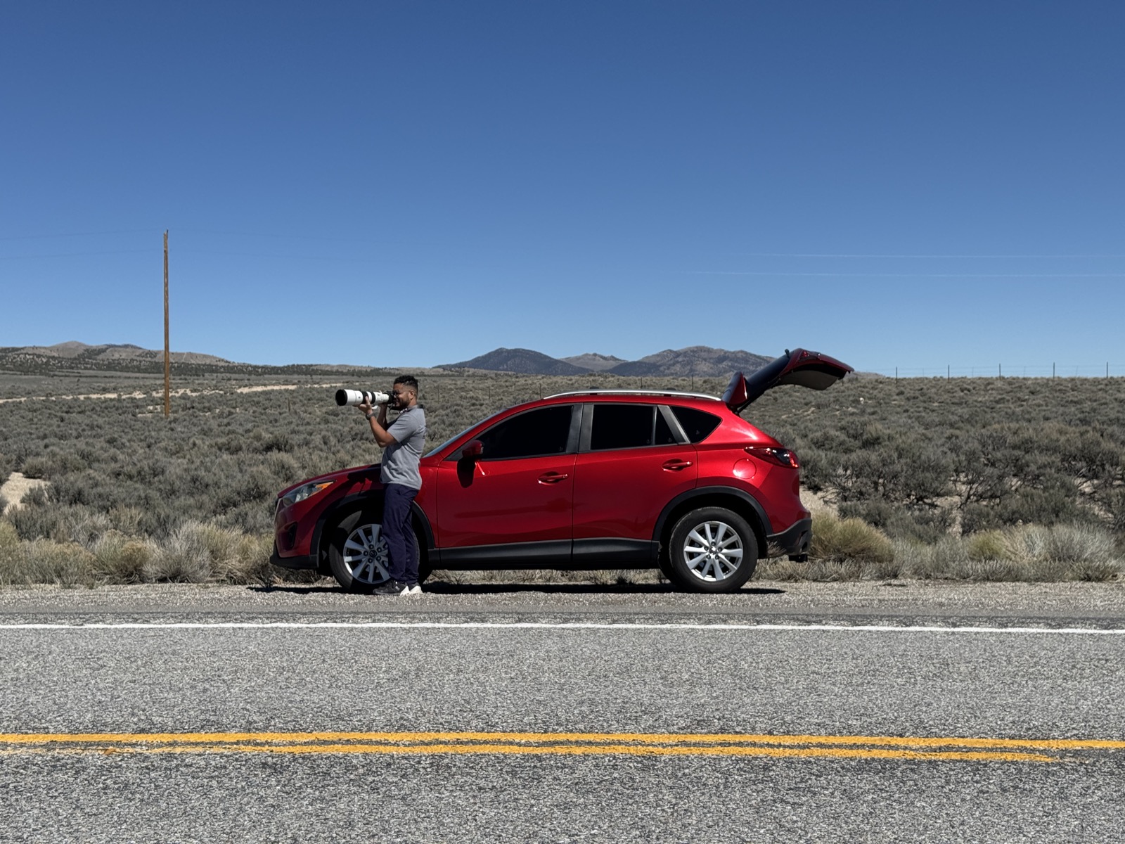Melvin Morales photographing the Nevada landscape along a desert highway